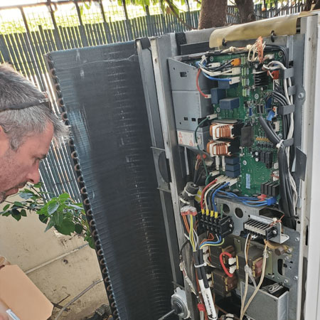 Un homme effectuant le dépannage de climatisation